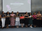As vencedoras do Prêmio do Selo de Direitos Humanos e Diversidade na categoria "Mulheres" estão de pé no palco, segurando os troféus e sorrindo.